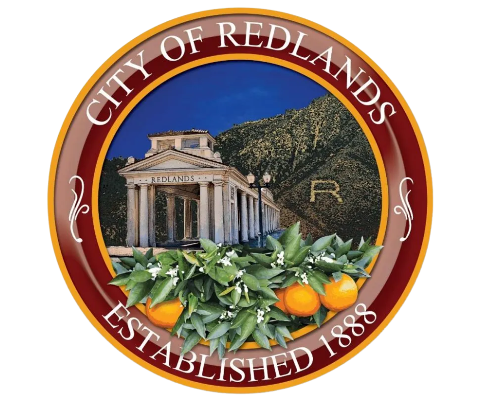 Seal of the City of Redlands featuring oranges, a historic building, and hillside with a large "R".